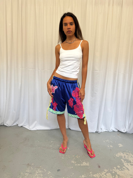 Blue shorts with pink and green lace